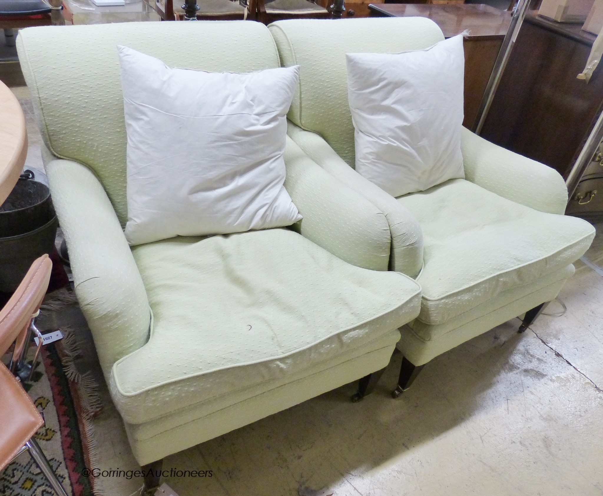 A pair of Howard style armchairs upholstered in lime green fabric. W-70, D-94, H-80cm.